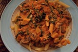Penne with mushrooms, zucchini, and spinach in a tomato cream sauce