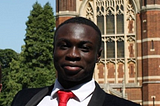 The author, smiling, at Selwyn College, Cambridge