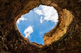 Worm’s-eye Photography of Hole Under Cloudy Sky