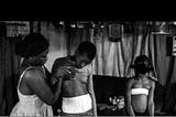 Veronica, 28, massages the breasts of her 10-year-old daughter, Michelle, as her other children…