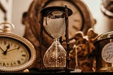 Antique hourglass and clocks