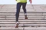 A runner running up a flight of concrete steps