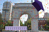 The Washington Square Park arch surrounded in confetti and wearing a purple grad cap. Also several question marks.