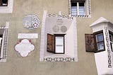 A town house in Pontresina located on via Maistra dating from 1709, lovingly restored in 2003. The sgrafitto features the family crests and historical references to the owners and occupants. The adorning patterns are geometric in nature and highlight the organic shapes of the window sills and bay window architecture.