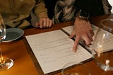 image of a finger pointing to a menu