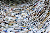 A tunnel made out of books is shown.