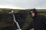 Photo of myself pretending to catch the water at the bottom of a waterfall