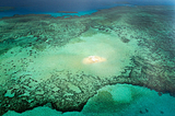 Small sand island in the middle of a coral reef, Australia