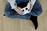 Picture of boy sitting holding a video game xBox controller