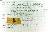 Aged graph paper with handwritten markings, including a moth taped to it. Popularly, the “first computer bug”