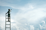 boy climbing up a ladder, reaching up to the sky, and touching it