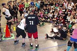 Natalie teaches a large group of skaters how to get low so you can execute a hit more effectively on your opponent.