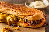 Homemade chop cheese sandwich with ground meat, American cheese, and ketchup.
