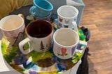 colorful coffee mugs sitting on a colorful platter