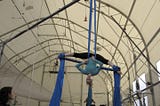 Author hanging upside down on aerial silks