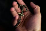 Unrecognizable man demonstrating anchor keychain on palm. Photo by Wallace Chuck via Pexels