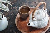 A Japanese-style teapot and a cup with a green tea