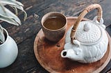 A Japanese-style teapot and a cup with a green tea