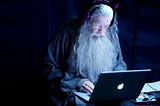 old wizard in front of a computer