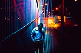 Person standing on a bridge in ultra-contrast lighting. Photo by Warren Wong on Unsplash.