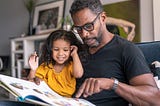 Father reading to his daughter