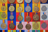 AI generated image (Stable Diffusion) | Prompt (by author): “A fauvist painting of many olympic medals”