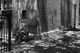 Grand Junction resident Warren Barnes, aka “the reading man” sits alone reading a book in an alley off Main Street in downtown Grand Junction on June 24, 2018. (William Woody, Special to The Colorado Sun)