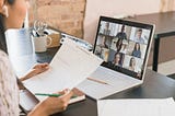 A person on the zoom video call having a conversation with her teammates