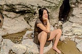 A young pregnant mother resting at the beach in the summer