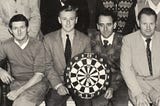 An old time picture of a dart throwing team.