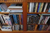 bookcase showing books and videos