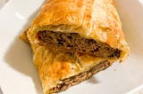 Puff pastry with pâté filling on a plate.