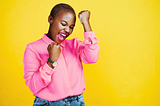 “I just keep winning” is a photo of a woman wearing a pink shirt and bold pink lipstick by Delmaine Donson via Canva Teams.