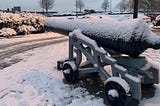 Antique cannon covered in snow