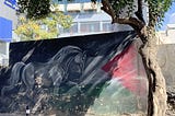 Horse and Palestinian flag, a mural by Sami al-Deek, emerging from the shadows, Ramallah, Palestine. 
 (Photo by the author, Oct. 13, 2023)