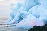 Lava pouring into ocean; forming new land while producing lots of billowing clouds