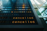 Cancelled flights are shown on display panel at airport