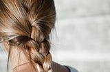 Girl with very shiny hair in a plait