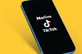 An image of a cellphone with the words “Native TikTok” on the screen.