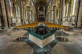 The Holy Fount in Salisbury Cathedral and a long view of the church interior with rows chairs up to the altar