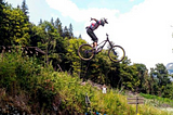 Videos of Mountain Biker Jumping Over The Tour de France Field