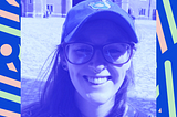 A photo of Niamh Broderick, a smiling woman wearing glasses and a cap.