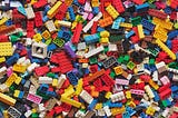 Many Lego blocks of different sizes, shapes, and colors