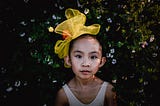 Picture of a young girl with a yellow ribbon in her hair who understand the power of mattering