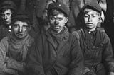 “Group of breaker boys — those who separated coal from impurities by hand” by Hine, Lewis on RawPixel