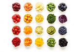 Bowls of fruit and vegetables arranged by color like the rainbow: red, orange, yellow, green, blue and purple.