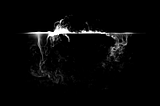 Mist spilling over edge of cup with dark background