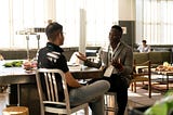 Two people talking in an office