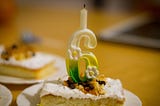 Slice of cake with candle.