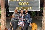 Mercy, Hope, and Ololade smiling wildly at the Lake Naivasha Sopa resort entrance